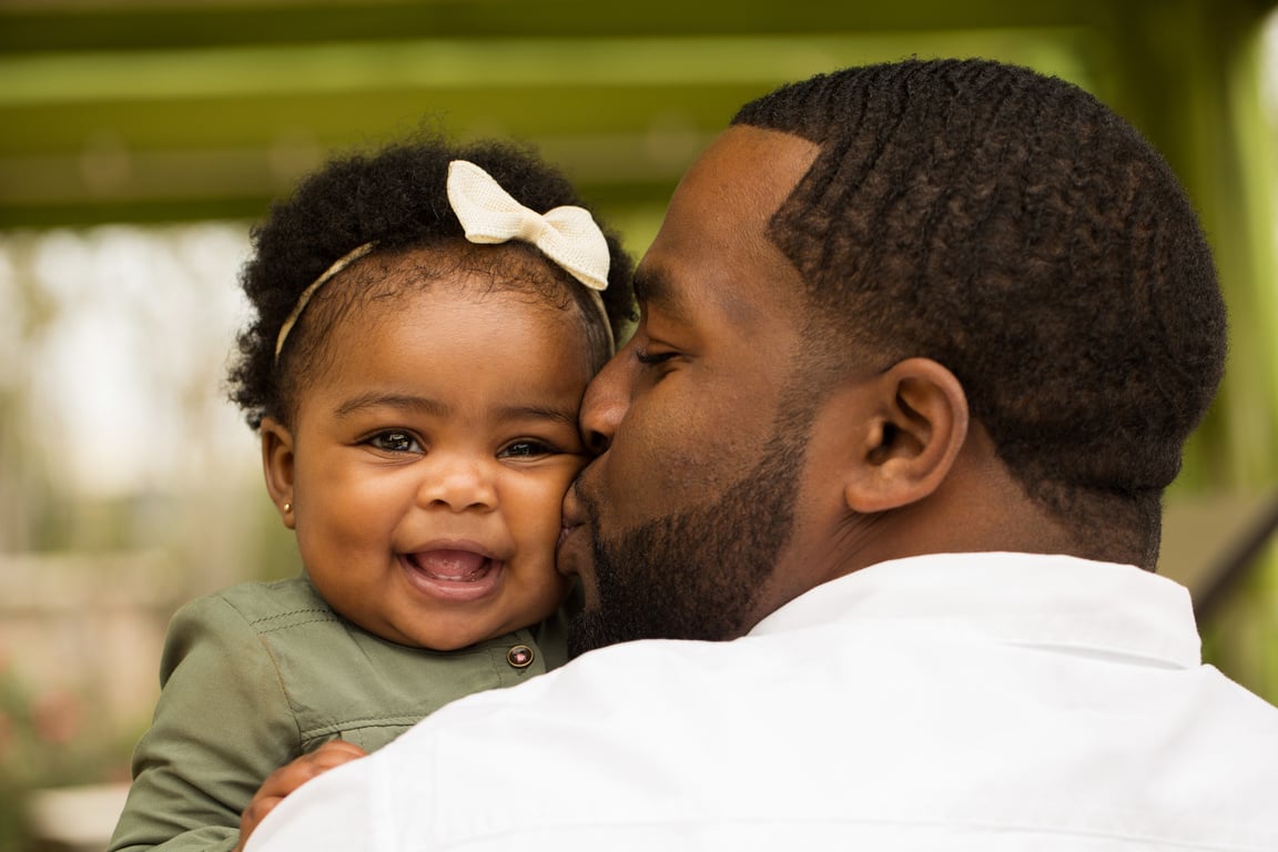 African American Father Holding His Daughter